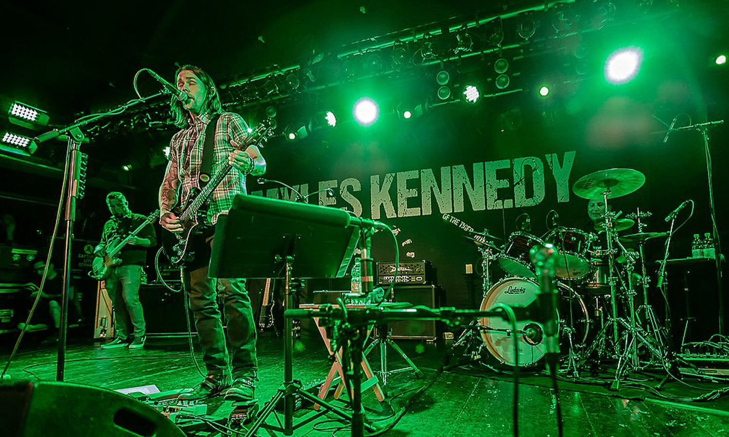 Sänger und Gitarrist Myles Kennedy steht mit akustischer Gitarre live auf der Bühne im Colos-Saal Aschaffenburg vor Publikum.